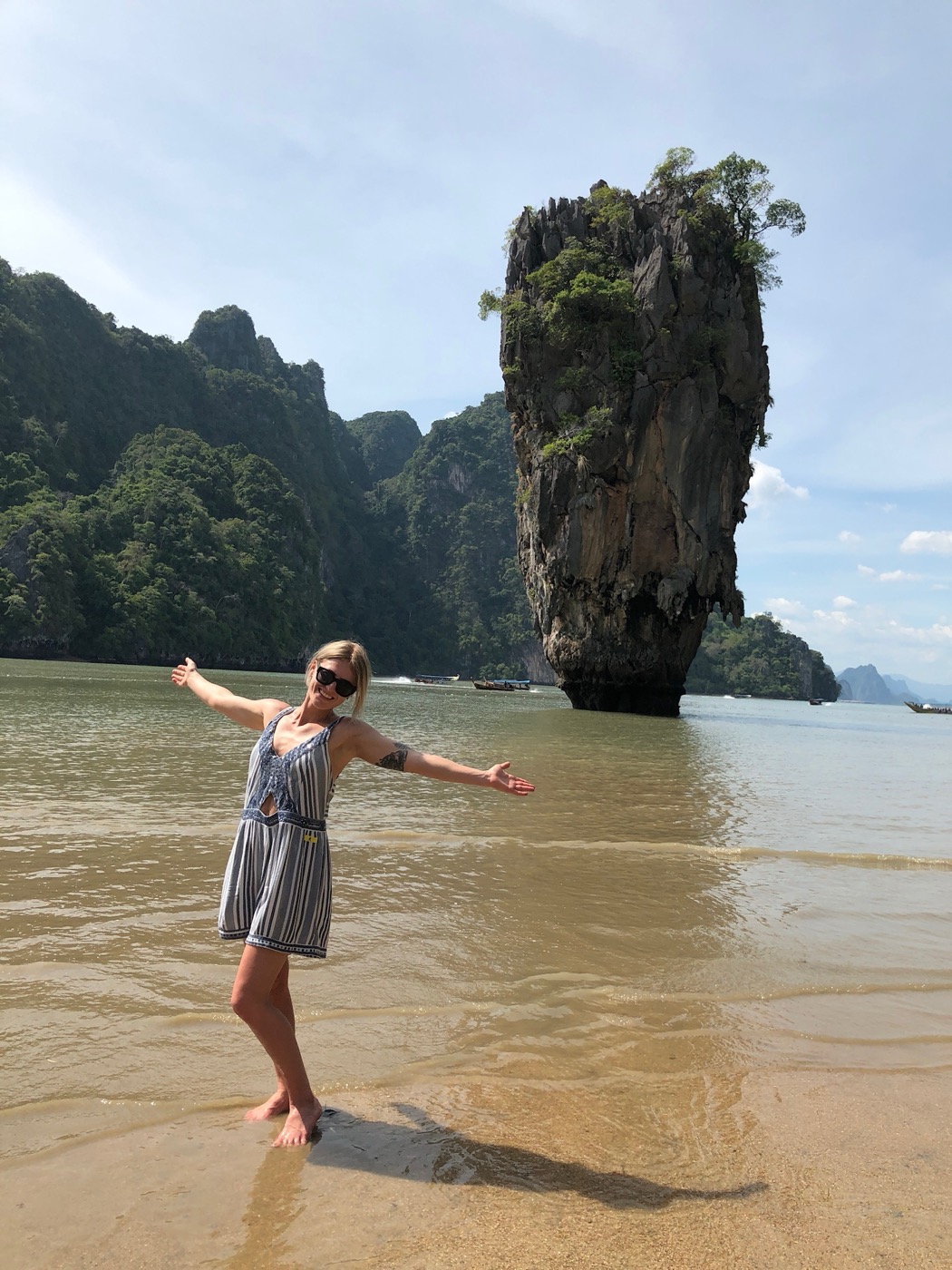 Hayley on the beach with arms open wide
