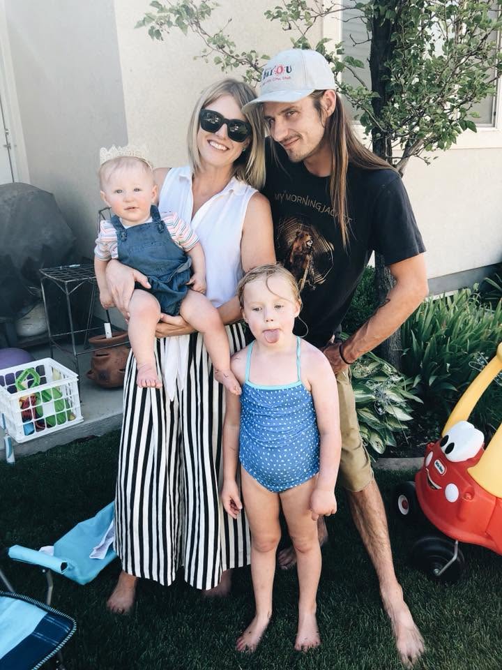 Hayley, Erik, and their daughters in the backyard